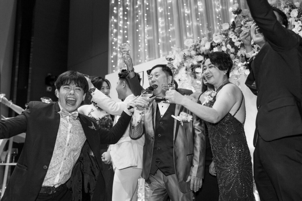 Wedding emceeing entertaining a crowd on stage for the Yum Seng Toasting Ceremony at a wedding banquet in Singapore.