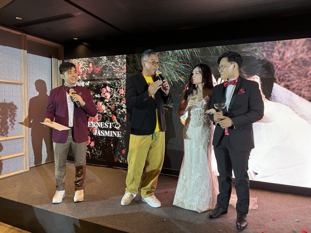 Wedding emcee on stage with Christopher Lee, Singapore actor in Singapore for a wedding.