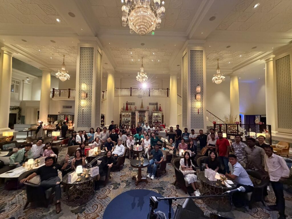 Group photograph of corporate celebration Christmas Party Dinner at Intercontinental Singapore Lobby Lounge, with trivia games, a singing and piano performance and lucky draw, organised by emcee, singer-pianist, event-planner De Zhong for Lectrix Engineering.