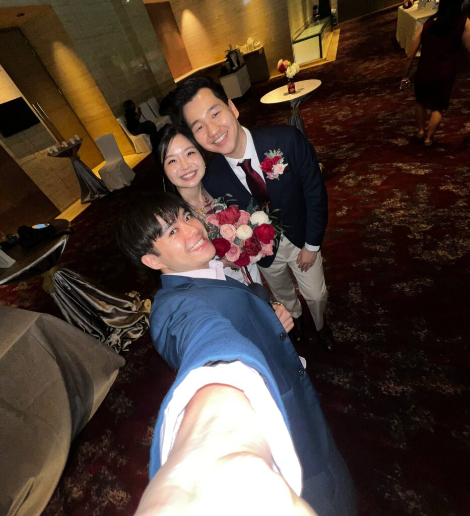 Wedding Emcee having a selfie moment with the couple at their wedding banquet, at Sheraton Towers in Singapore.