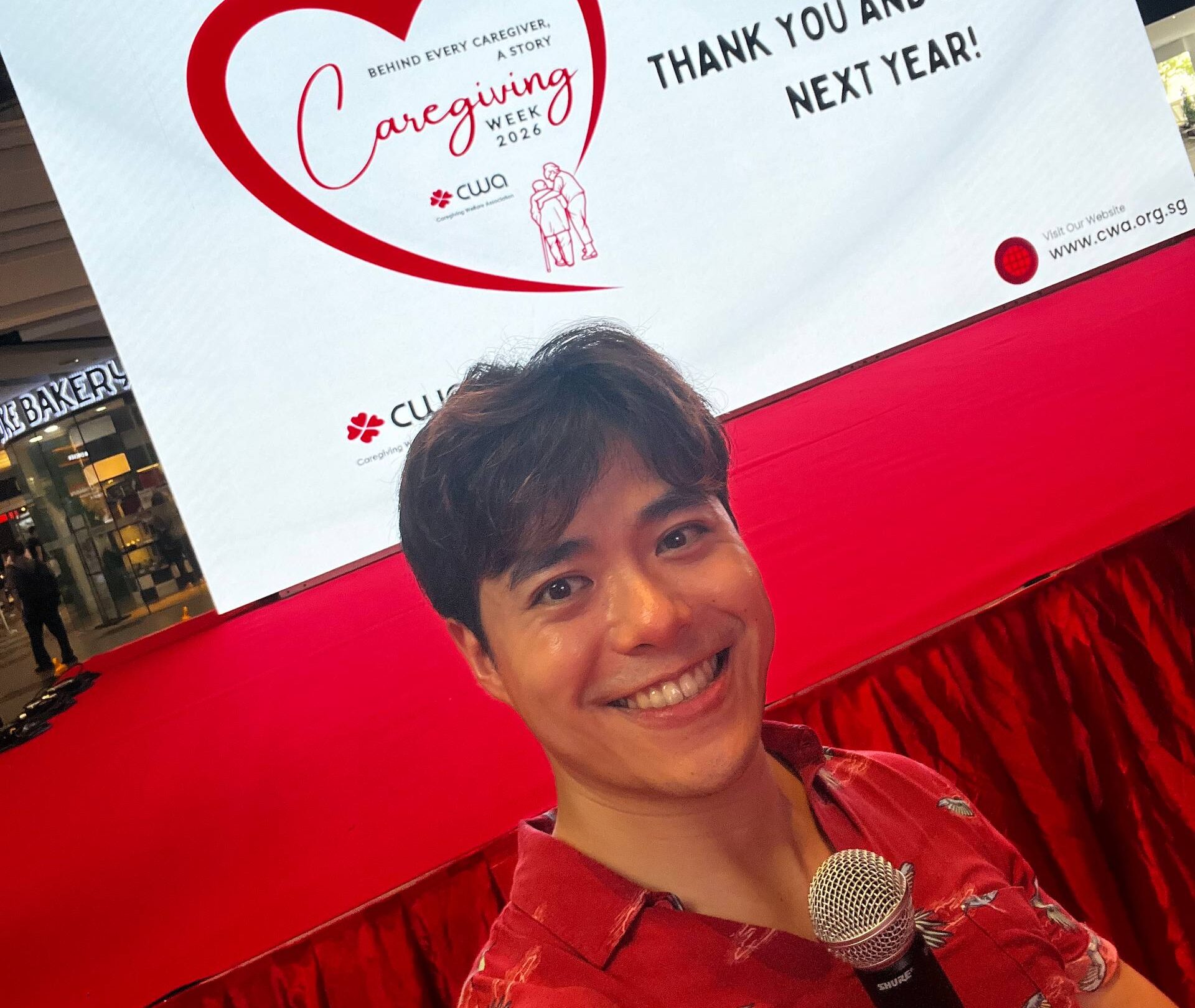 Singapore emcee De Zhong hosting a Caregiving Welfare Association charity event on stage